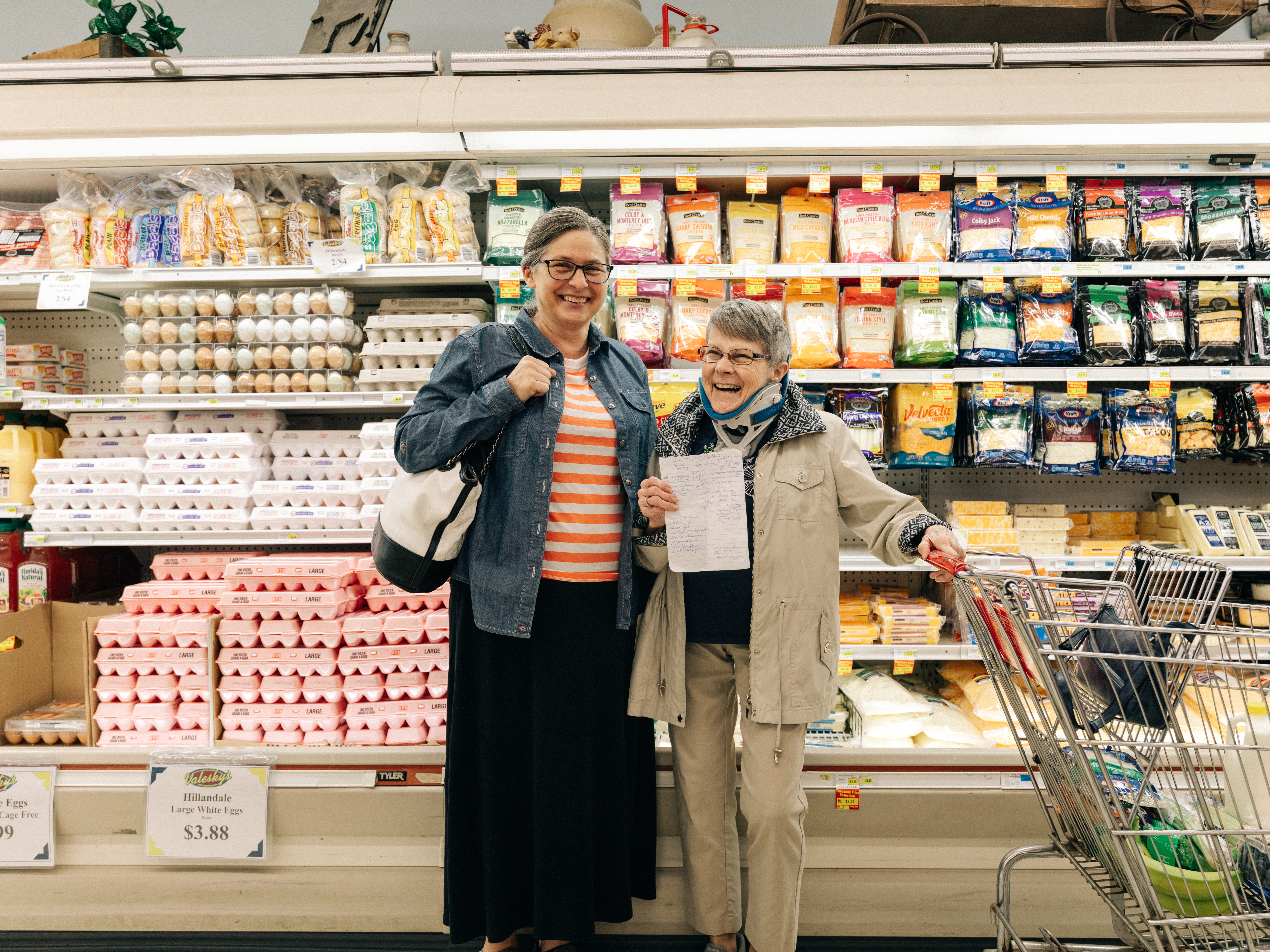 Jo and Karen standing together and smiling in the grocery store