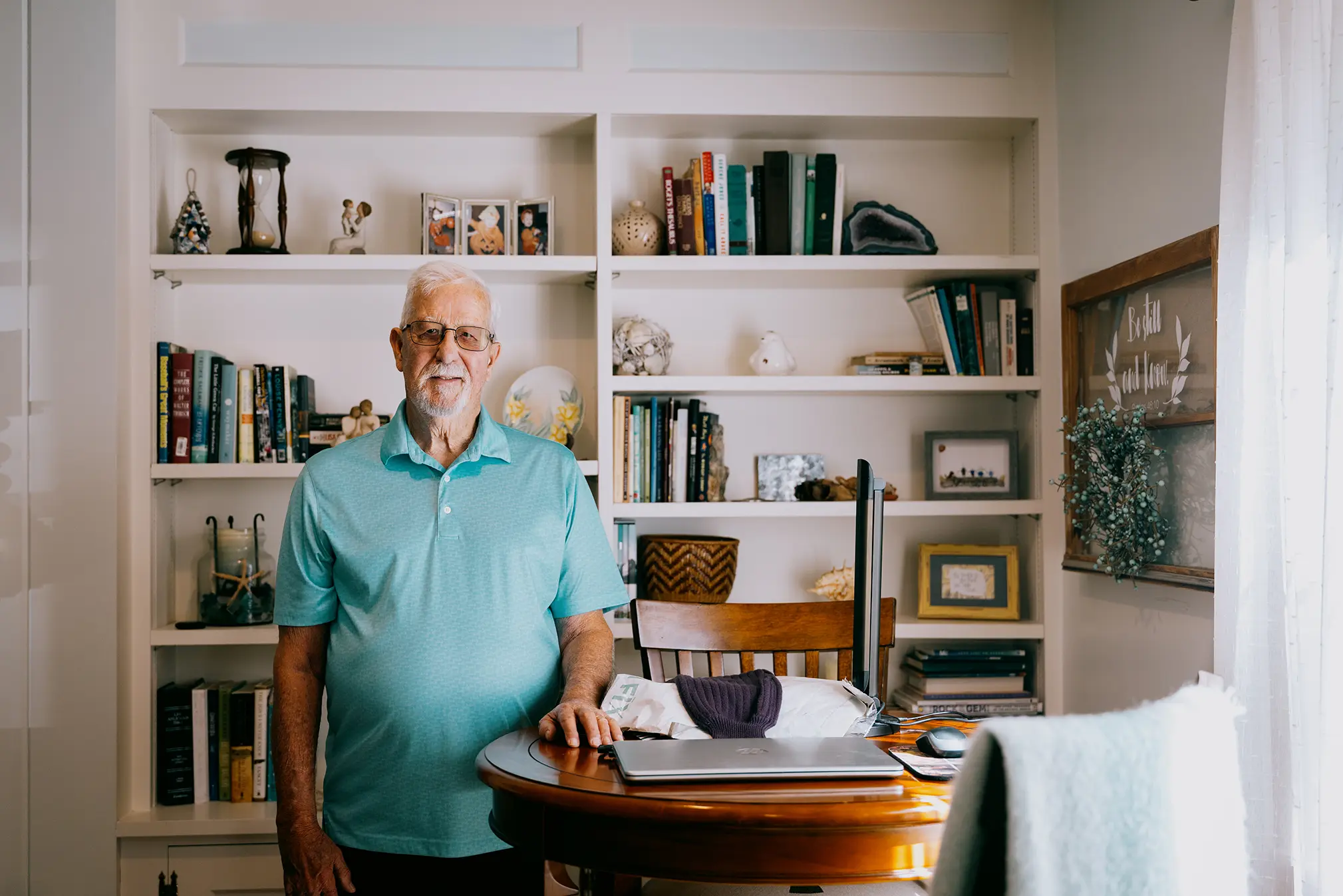Ken standing in front of a bookshelf.